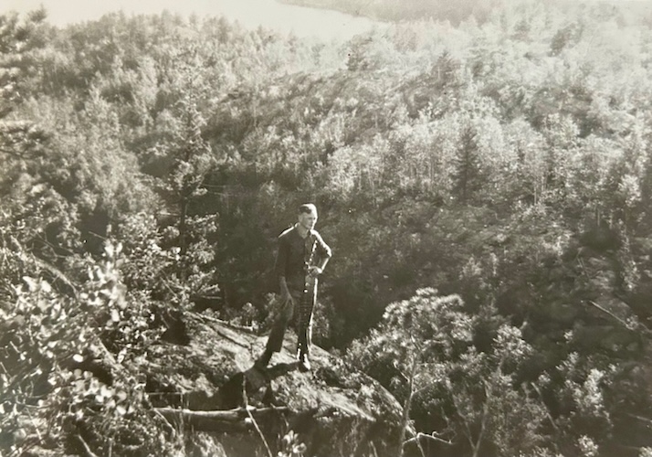man standing on rocky outcrop